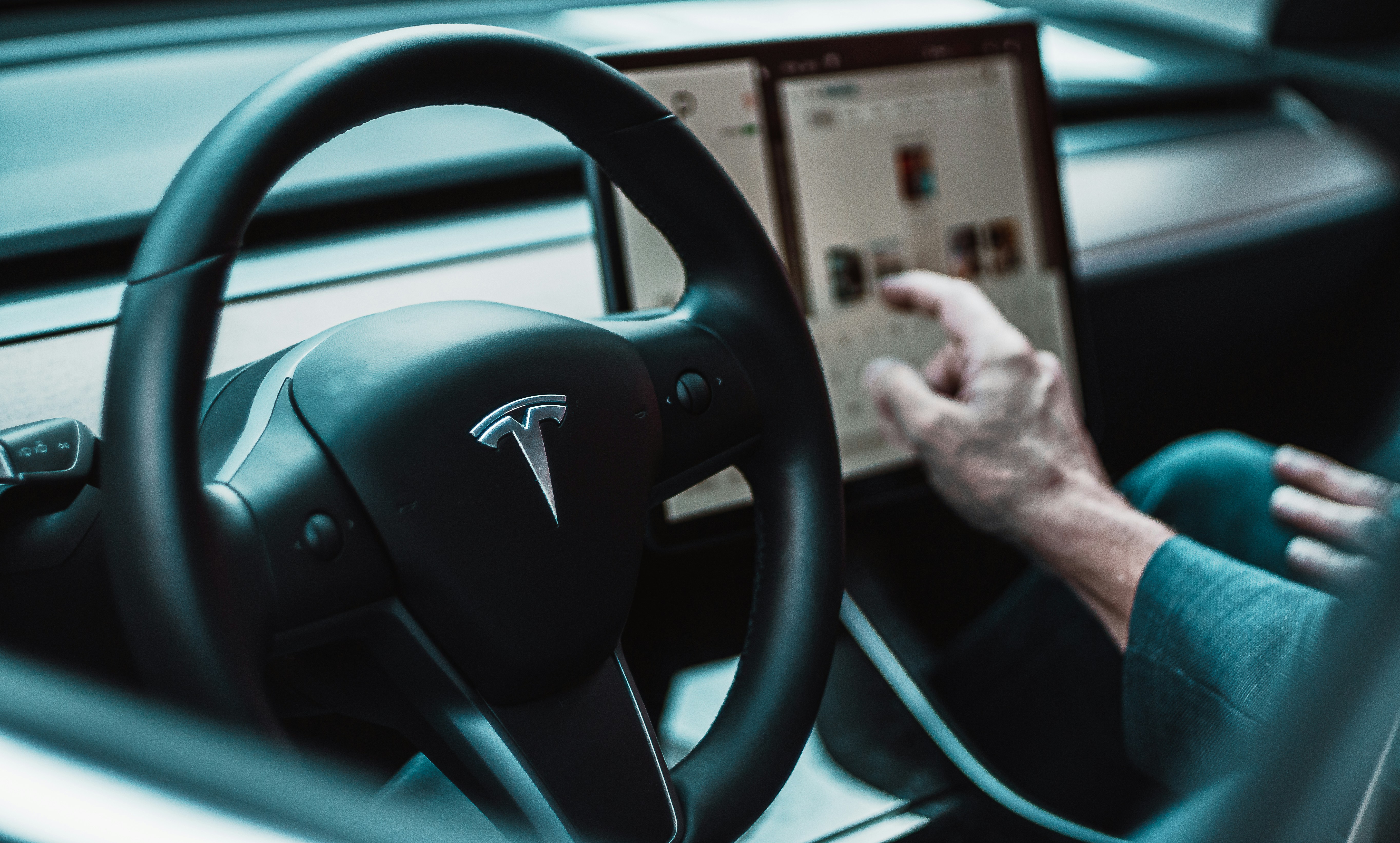 Tesla cabin: the wheel with the centre touchscreen off to the driver's right